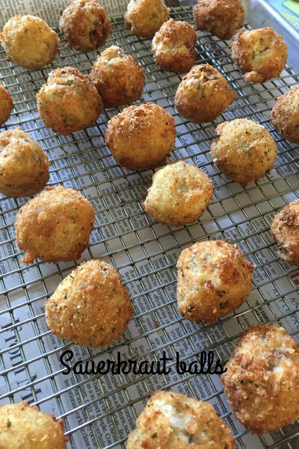 some food that is sitting on a wire rack in front of a tray full of muffins