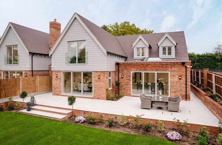 a large house with an outdoor patio and seating area