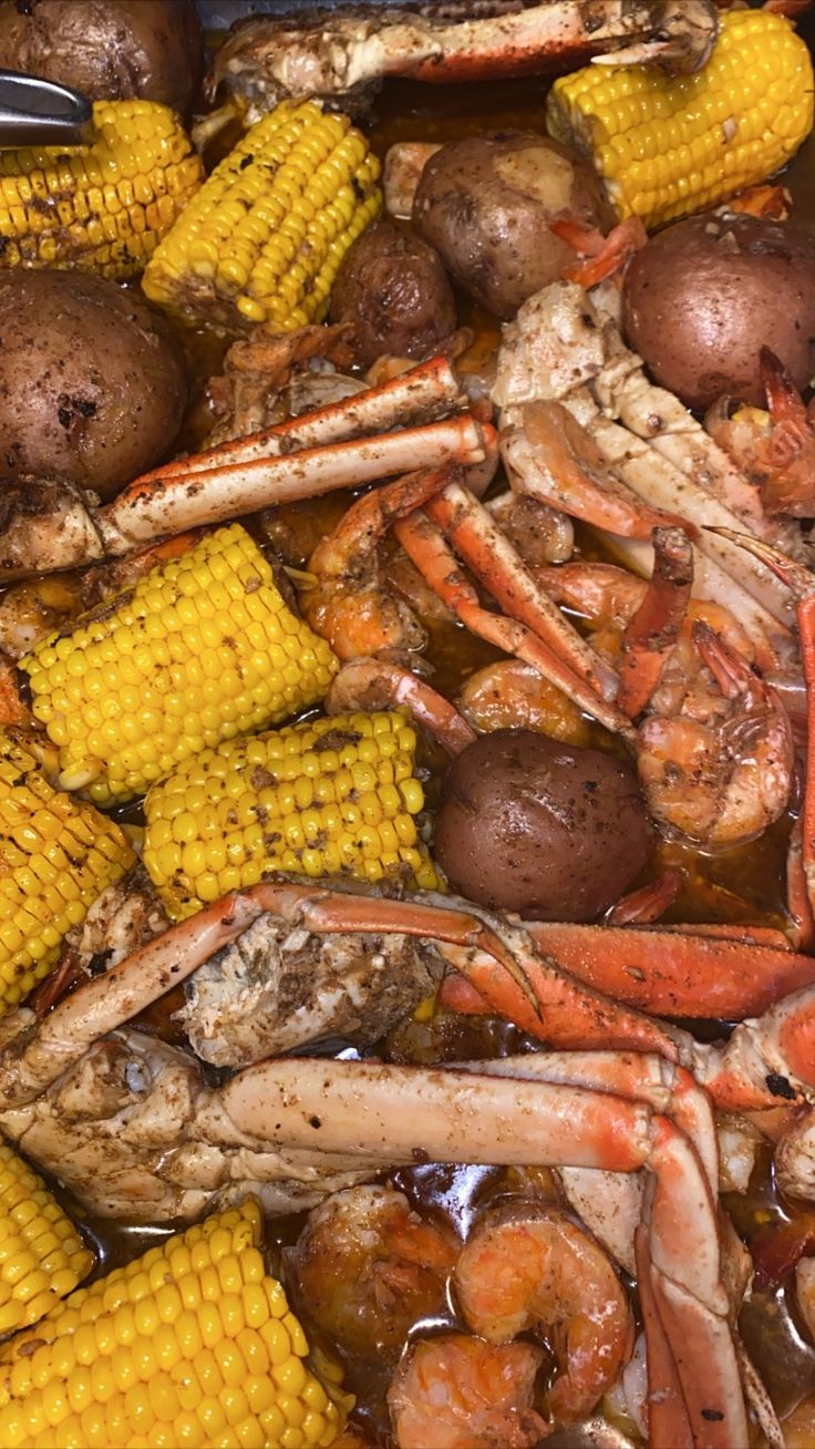 crab, corn and potatoes are being cooked together