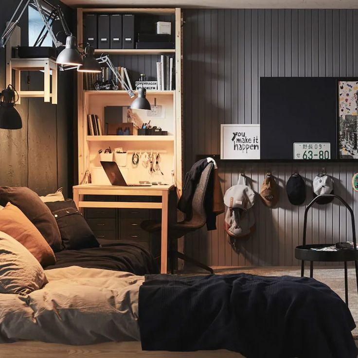 a bed sitting in a bedroom next to a desk and shelves filled with books on top of it