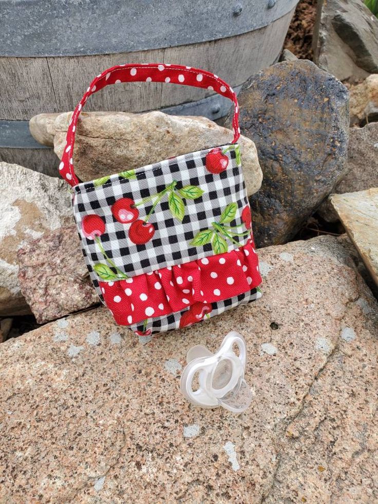 "Baby's First Purse. You are never too young for your first purse. This adorable tiny cherry purse makes the perfect gift for a baby girl or one year old. This purse is made from a fun cherry and gingham print. The ruffle and handle is a fun red and white polka dot print dot print. This is very small only measuring 3.5\" tall & 4.25\" wide. The little handle drops 4.5\" Perfect gift for a newborn, baby shower, or first birthday!" Cherry Purse, Handbags For Girls, Diy Handbags, Toddler Purse, Bags Sewing, Girls Tote, Tote Bags Sewing, Fabric Purses, Diy Handbag