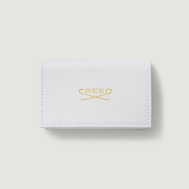 Women's Leather Sample Wallet - White | Creed Boutique Elegant Smooth Grain Leather Card Holder For Formal Use, Elegant Trifold Wallet With Rfid Blocking For Formal Events, Chic Rectangular Card Holder For Gift, Modern White Wallet As Gift, Classic Saffiano Leather Wallet With Rfid Blocking, Luxury White Wallet Perfect For Gift, Elegant Bifold Card Holder For Travel, Chic Bifold Card Holder With Interior Slots, Elegant Wallets With Smooth Grain For Gift