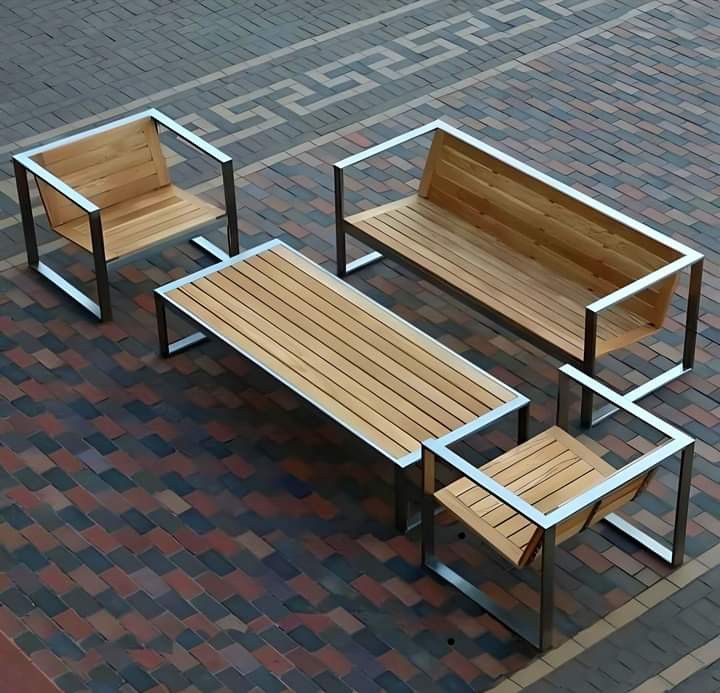 three wooden benches sitting next to each other on top of a brick floor covered ground