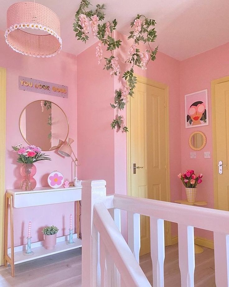 a pink and yellow room with flowers on the wall