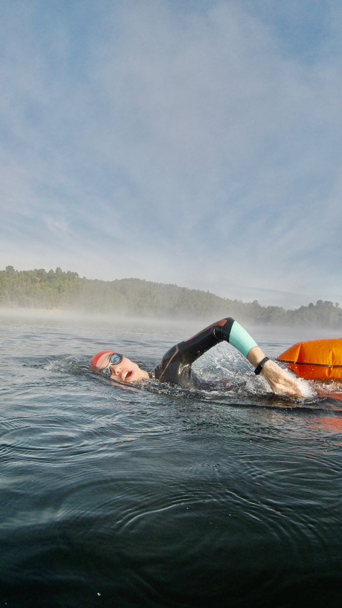 a man laying on top of a surfboard in the water