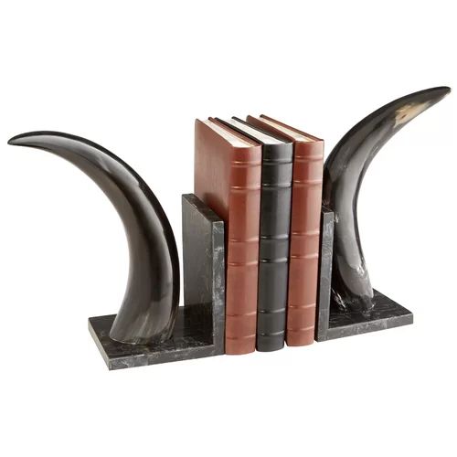 three books are stacked on top of each other in front of a bookend made out of metal and marble