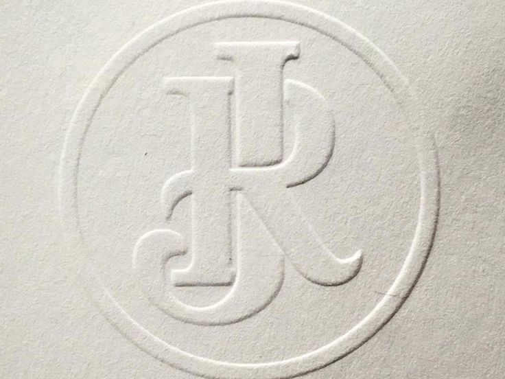 the letter j is inscribed in white paper with a circular design on it's side