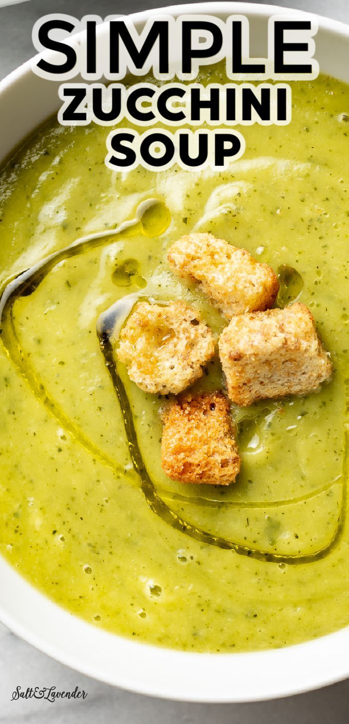 a white bowl filled with green soup and croutons on the side, text overlay reads simple zucchini soup