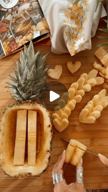 pineapple slices cut into heart shaped shapes on a cutting board next to other food items