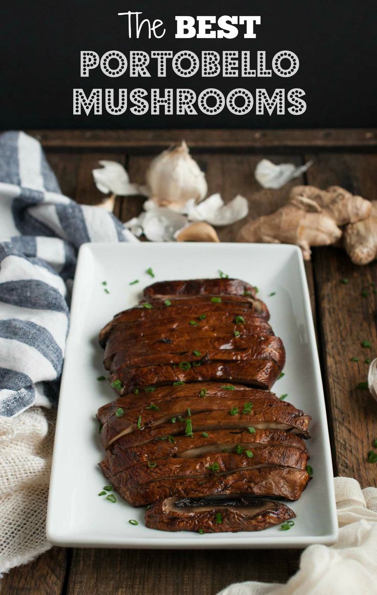 the best portobello mushrooms on a white plate with garlic and parsley