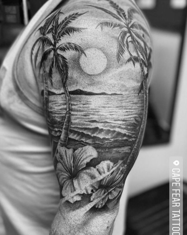 a man's half sleeve with palm trees and the sun in the sky behind him