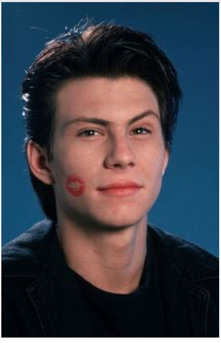 a young man with red paint on his face