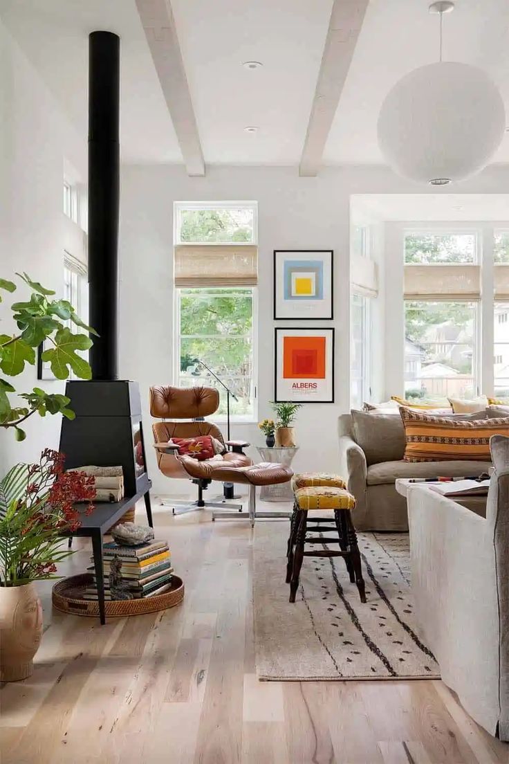 a living room filled with furniture and a fire place in the middle of a room