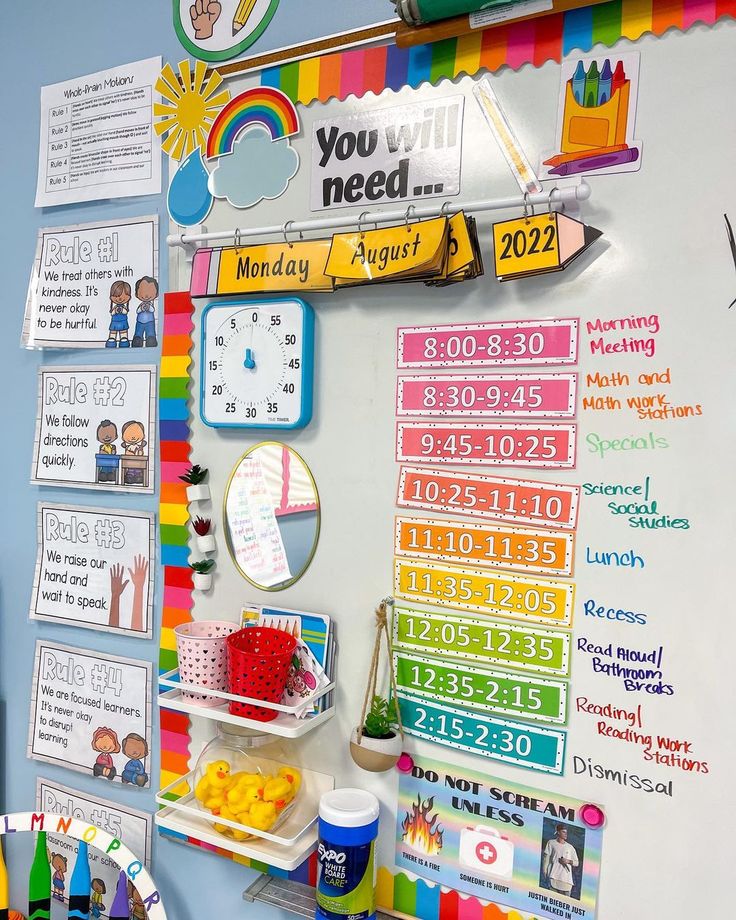 a bulletin board with colorful writing and magnets on it's side next to a clock