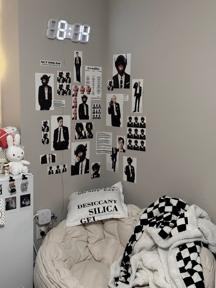 a bed room with a neatly made bed and pictures on the wall above it,