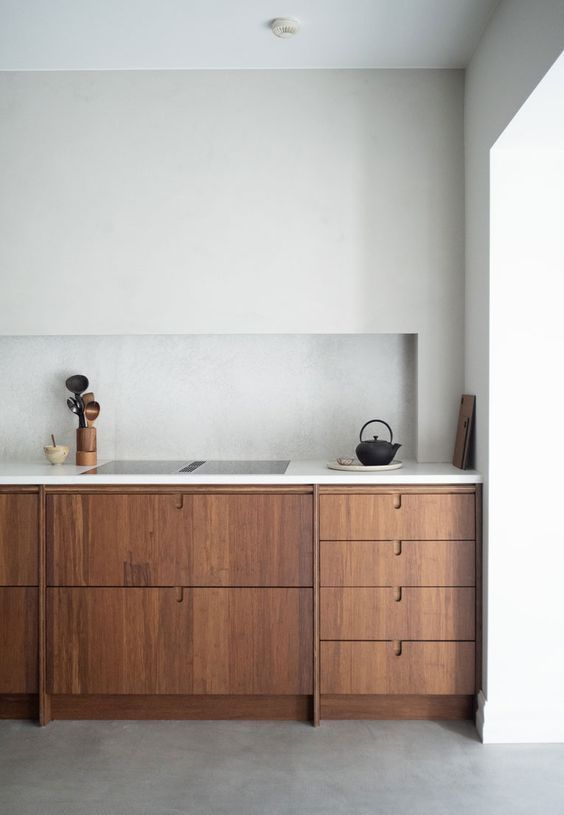 a kitchen with wooden cabinets and white counter tops