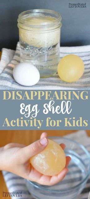 an egg shell is being held in front of a glass jar