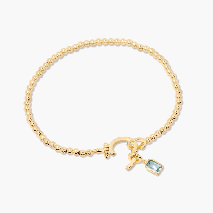 Treat your wrists to some bling with the Mackenzie Birthstone Bracelet. With a vivid birthstone charm, and intricately-beaded gold, this sparkling accessory is sure to add a touch of glam to any outfit. Avery Bracelet: Available in 14k gold plated or rhodium plated brass, 6" bead bracelet, hinge closure measures 1/2", 4mm beads Mackenzie Hinge Birthstone Charm: Available in 14k gold plated sterling silver or rhodium plated sterling silver1/8"x1/4" charm, 5mm Cubic Zirconia NOTE - open bracelet h Gold Beaded Bracelets With Gemstone Accents, Gold Bracelets With Gemstone Accents And Round Beads, Adjustable Gold Beaded Bracelets With Gemstone Accents, Elegant Gold Gemstone Charm Bracelet, Elegant Gold Crystal Bracelet With Birthstone, Elegant Gold Beaded Bracelets With Gemstone Accents, Elegant Gold Crystal Birthstone Bracelet, Elegant Gold Charm Bracelet With Birthstone, Gold Crystal Bracelet With Birthstone