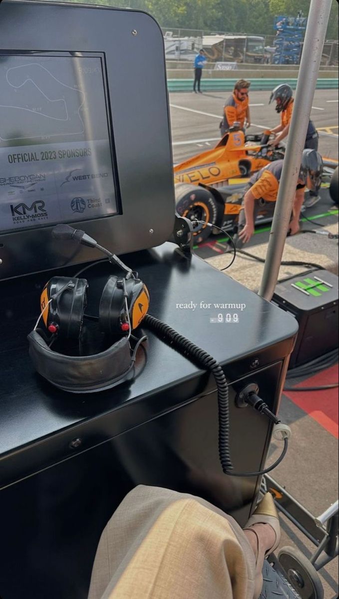 an electronic device is sitting on top of a black box in the middle of a race track