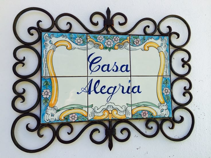 there is a sign on the wall that says casa meerja in blue and yellow