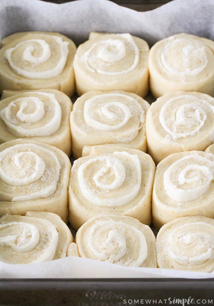 rolls in a pan with white frosting on top