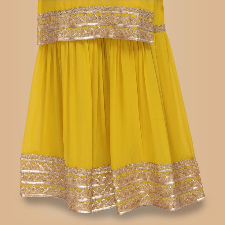 Looking for an elegant and sophisticated garara set that is perfect for any special occasion? Then look no further than our Elegant Garara Set with Gold Accent! This beautiful set features a simple garara silhouette with stunning heavy gold gota accents on the edge of the top, garara and dupatta. The yellow color is perfect for any event, day or night, and will make you stand out from the crowd. Whether you're attending a wedding, engagement party or other formal event, this garara set is sure t Yellow Floor-length Sharara For Festive Season, Yellow Floor-length Sharara With Gota Work, Yellow Garara, Yellow Unstitched Floor-length Sharara, Yellow Floor-length Sharara For Festivals, Ready To Wear Saree, Sari Blouse, Exclusive Collection, Saree Blouse