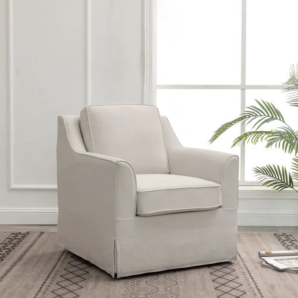 a white chair sitting in front of a window next to a potted palm tree