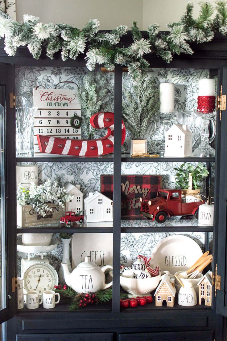 a china cabinet with christmas decorations on it