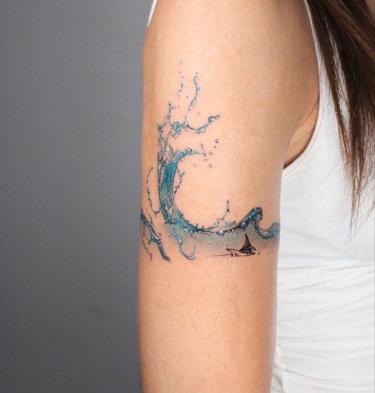 a woman with a wave tattoo on her arm