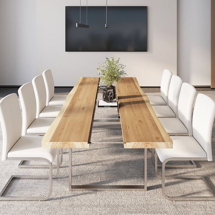 a long wooden table with white chairs and a potted plant on the end in front of it