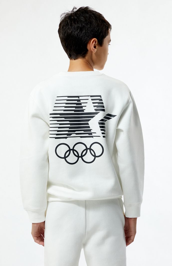 Gear up for a stylish victory lap with the Olympic Kids LA 1984 Olympic Sweatshirt. Featuring long sleeves, a soft fleece lining, and a classic crew neckline, this sweatshirt keeps you cozy while you show off your Olympic spirit. With bold Olympics graphics, it's the perfect way to celebrate the thrill of the games in iconic style.


	Solid color sweatshirt
	Long sleeves
	Crew neckline
	Soft fleece lining
	Ribbed trimming
	Olympics graphics
	Regular fit
	Machine washable Olympic Outfits, Olympics Graphics, Olympic Podium, Kids Olympics, Boston Trip, 1984 Olympics, Gymnastics Shirts, Color Sweatshirt, Olympic Gymnastics