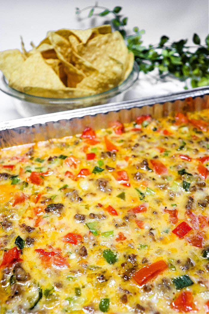 an enchilada casserole with tortilla chips on the side