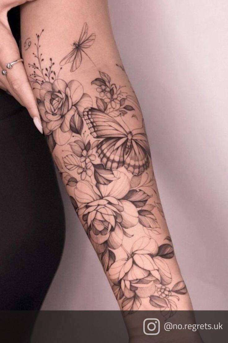 a woman's arm with flowers and butterflies tattoo on her left arm, while the other half is black and white