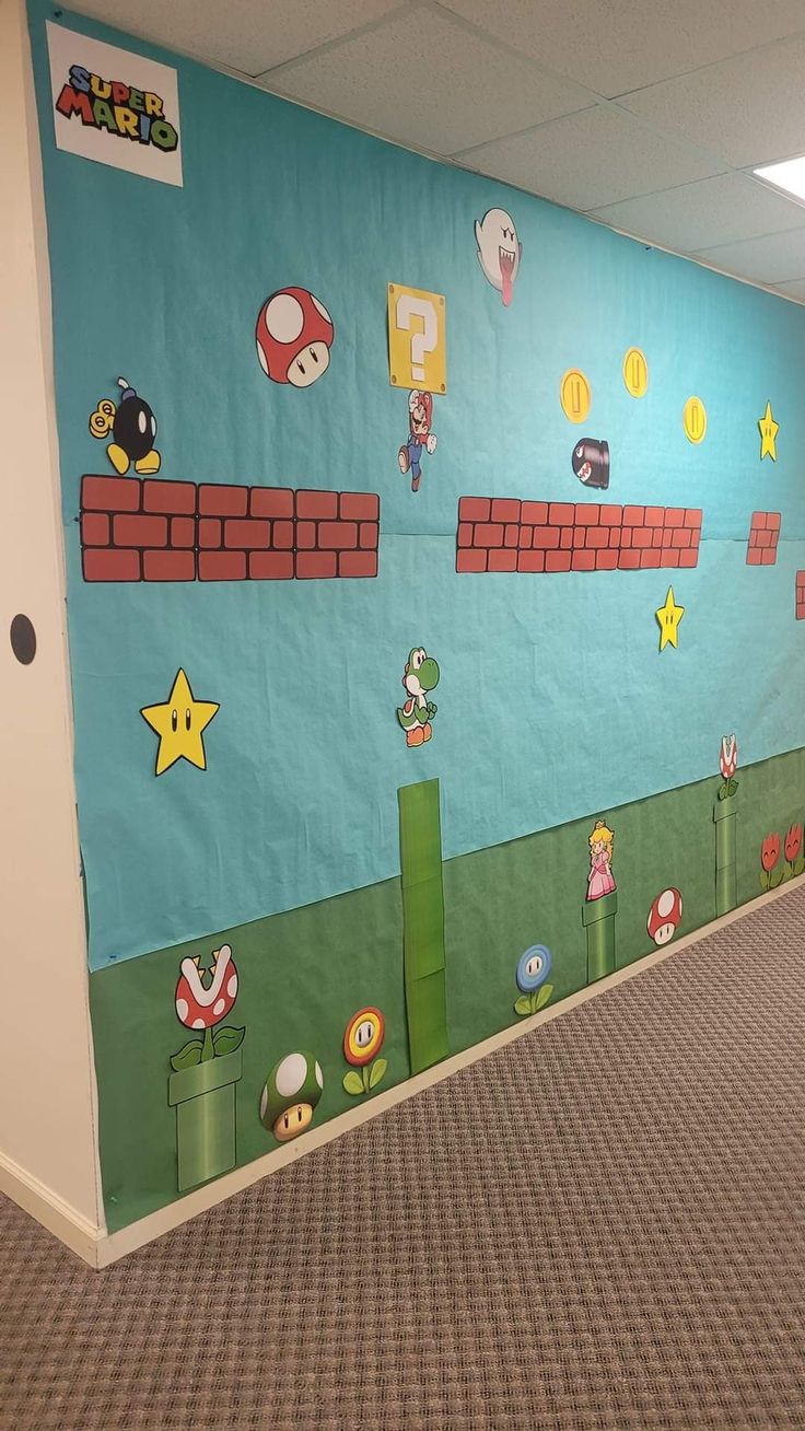 an office hallway decorated with mario bros wallpaper and carpeted flooring, along with video game characters on the walls