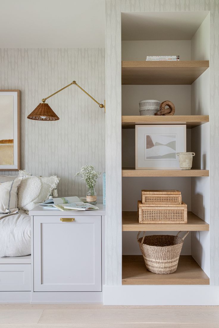 a bedroom with shelves, baskets and pictures on the wall