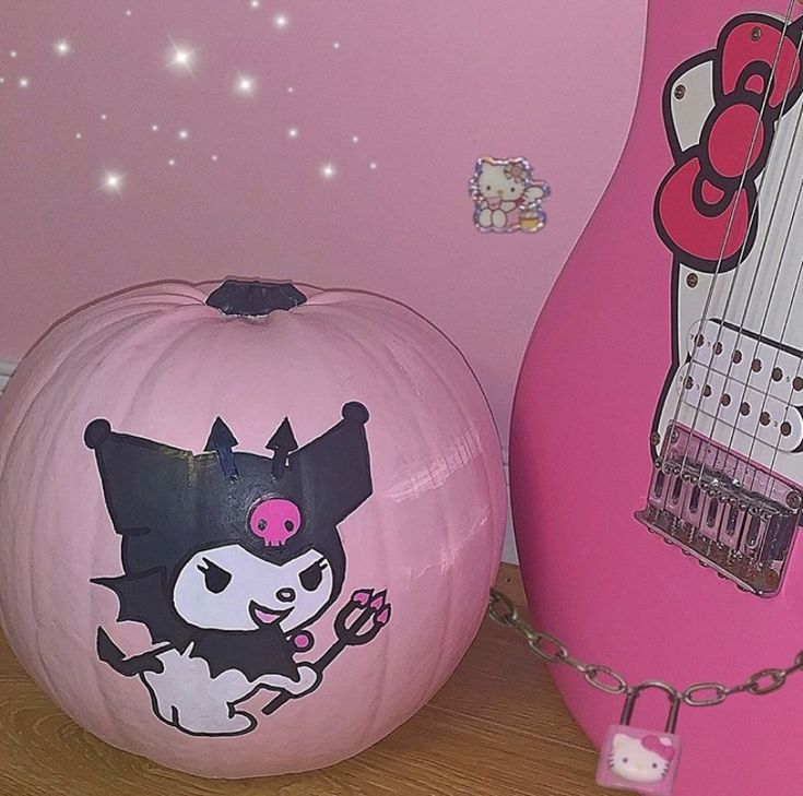 two pumpkins with cartoon characters painted on them, one is pink and the other is white