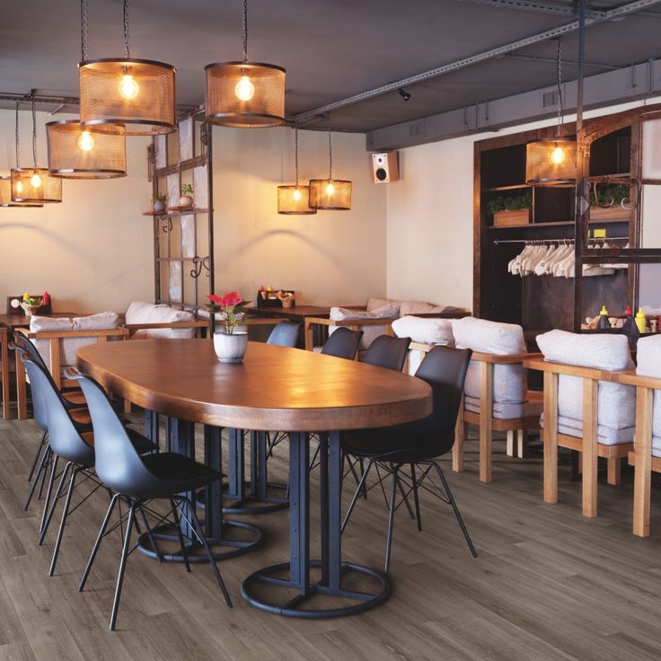 a restaurant with wooden tables and blue chairs