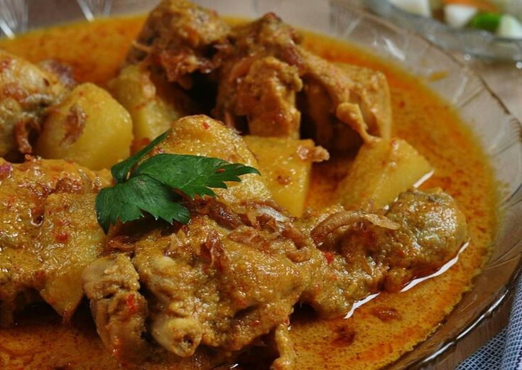 a bowl filled with meat and potatoes covered in gravy