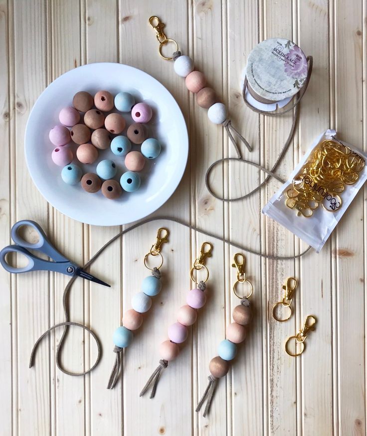 beads, scissors and other crafting supplies are laid out on a table