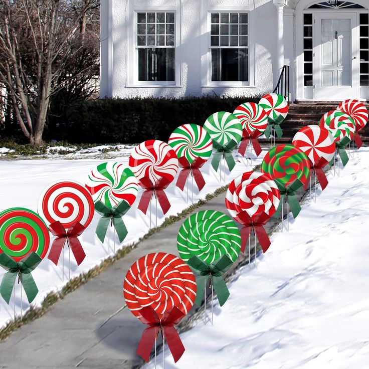 candy canes lined up in front of a white house