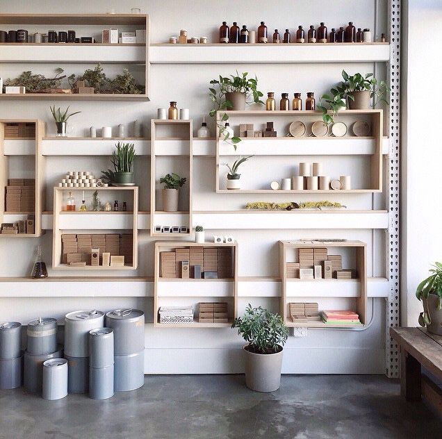 many shelves with plants and pots on them