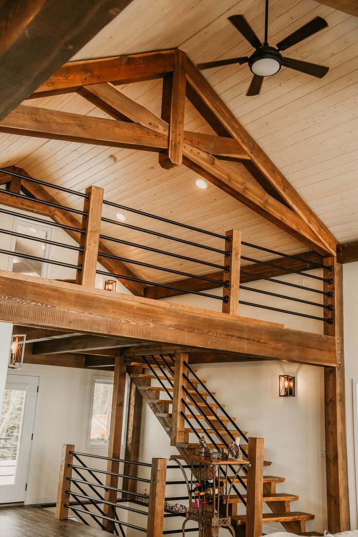 a living room filled with furniture and a wooden ceiling mounted to the side of a wall