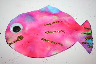 a pink fish with gold glitters on it