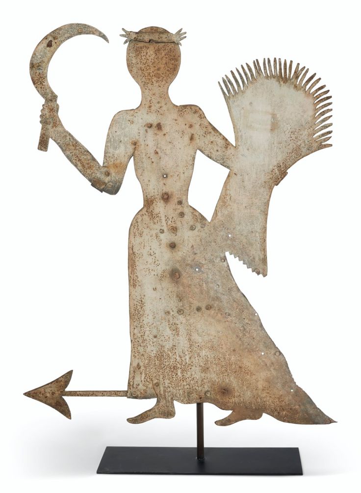 a statue with an arrow in it's hand and a woman holding a bird