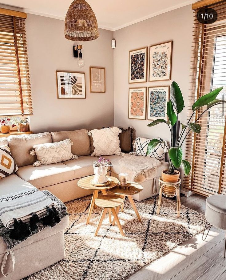 a living room filled with lots of furniture and pictures on the wall above it's windows