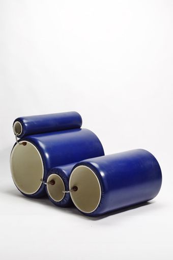 two blue cylinders sitting next to each other on a white surface in front of a plain background