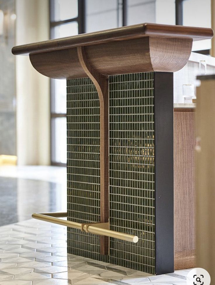 a wooden podium with a metal handle on the front and back sides in a room