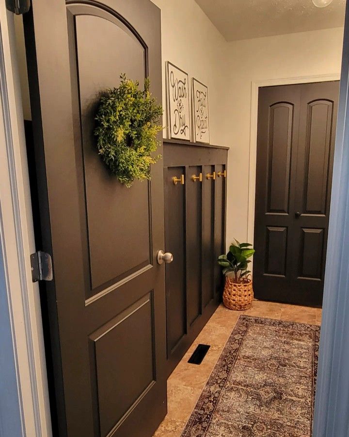 a door with a wreath on the front and two doors to another room behind it