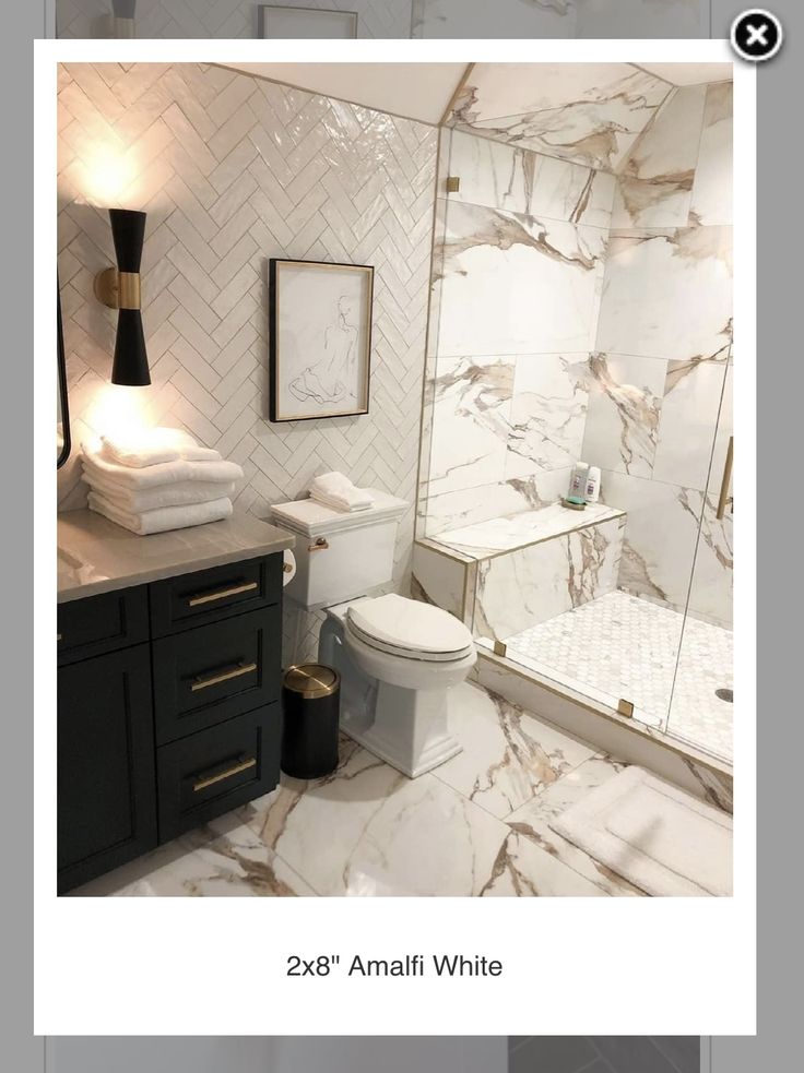 a bathroom with white marble walls and floor