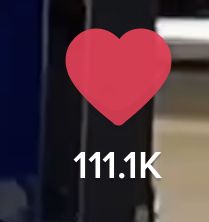 a heart sticker on the side of a blue car with white lettering that reads 11 1 k